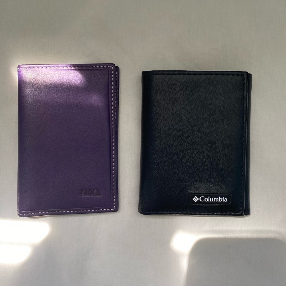 two mens’ wallets: Columbia and Fancil